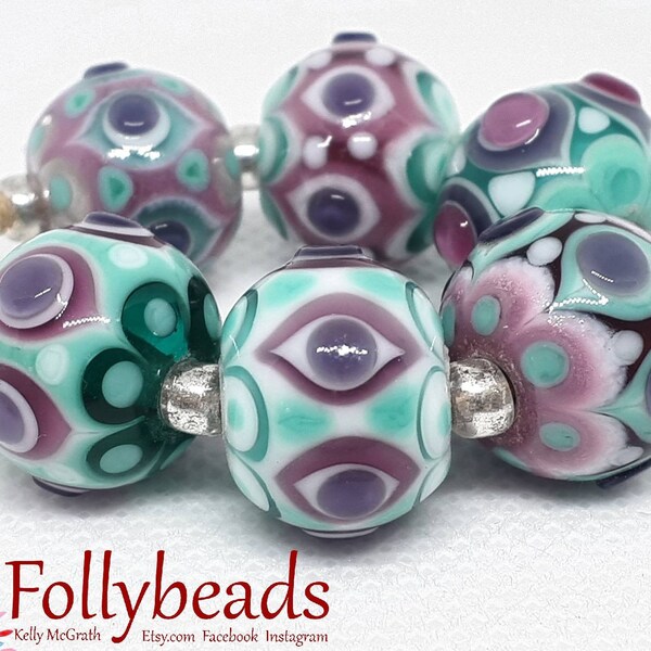 Handmade Lampwork Artisan glass bead set in transparent and opaque Pink, Purple, Teal and White.