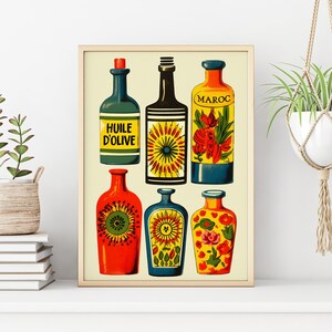 May include: A framed print of six colourful bottles with floral designs and text. The bottles are labelled "Huile d'Olive" and "Maroc".