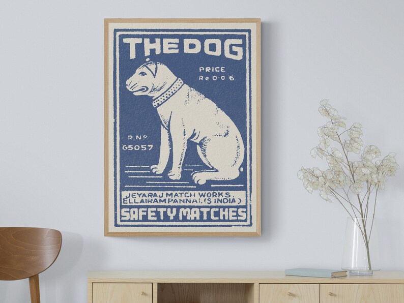 May include: Vintage blue and white matchbox label with a cartoon dog illustration. The label reads "The Dog" and "Safety Matches".