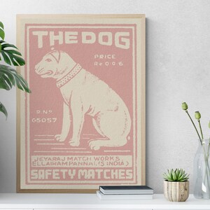 May include: A vintage-style illustration of a dog on a pink background. The illustration is framed and has the text "THE DOG", "PRICE Re 006", "R.N 65057", "JEYARAJ MATCH WORKS. ELLAIRAM PANNAI.IS INDIA)", and "SAFETY MATCHES".