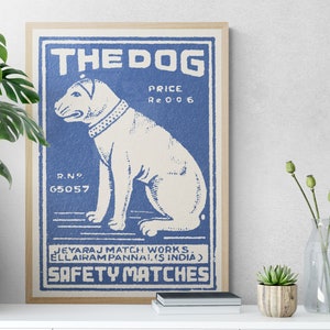 May include: Vintage blue and white matchbox label with a cartoon illustration of a dog and the text "THE DOG", "PRICE Re 0 0 6", "R.NO. 65057", "JEYARAJ MATCH WORKS. ELLAIRAM PANNAI. (S INDIA)", and "SAFETY MATCHES".