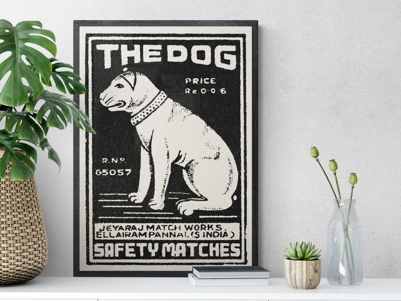 May include: Black and white vintage matchbox label with a dog illustration. The label reads "THE DOG", "PRICE Re 0 0 6", "R.N.P. 65057", "JEYARAJ MATCH WORKS. ELLAIRAM PANNAI. (S INDIA)", and "SAFETY MATCHES".