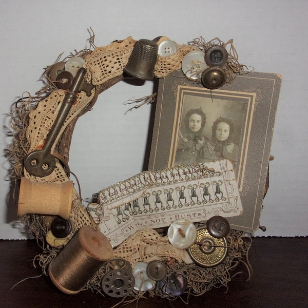 Collage of Vintage/Antique Items on Wreath - Spools of Thread, Key, Thimble, Buttons, Snaps on Card, Lace Piece, Old Photo of 2 Little Girls