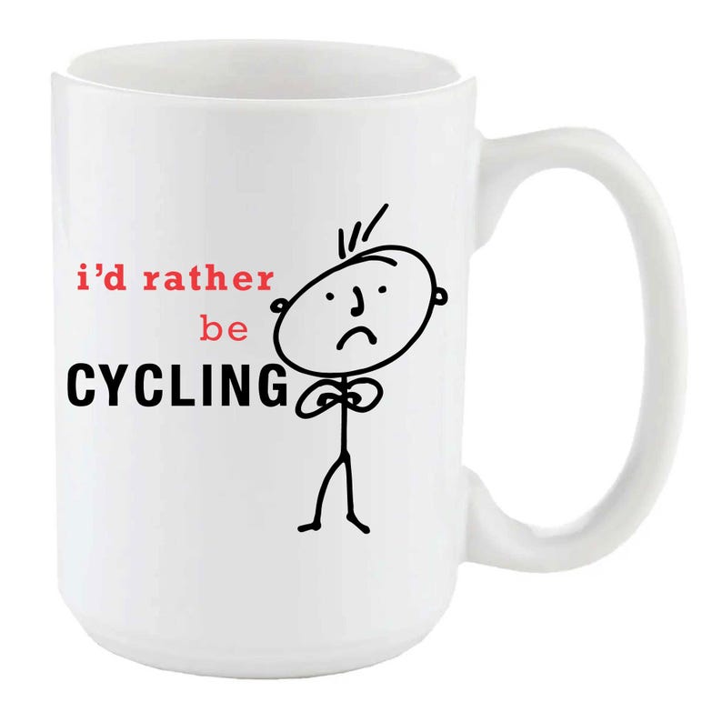 May include: White ceramic mug with a black and white illustration of a person with a sad expression. The mug has the text "i'd rather be CYCLING" in black and red.