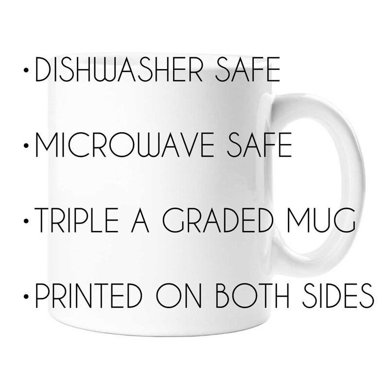 May include: White ceramic mug with black text that reads "DISHWASHER SAFE", "MICROWAVE SAFE", "TRIPLE A GRADED MUG", and "PRINTED ON BOTH SIDES".