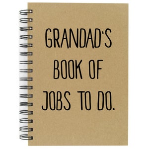 May include: A brown spiral bound notebook with the text "GRANDAD'S BOOK OF JOBS TO DO." printed in black.