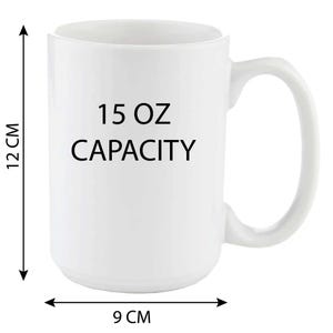 May include: White ceramic mug with a black inscription that reads "15 OZ CAPACITY". The mug has a handle and is 12 inches tall and 9 inches wide.