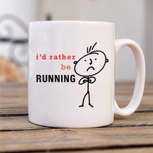 May include: White ceramic mug with a black and white stick figure illustration. The mug has the text "i'd rather be RUNNING" in black and red.