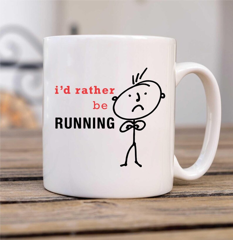 May include: White ceramic mug with a black and white stick figure illustration. The mug has the text "i'd rather be RUNNING" in black and red.