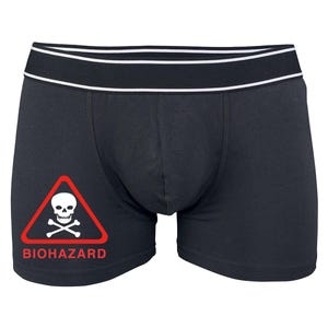 May include: Black boxer briefs with a white skull and crossbones graphic inside a red triangle with the word "BIOHAZARD" underneath.