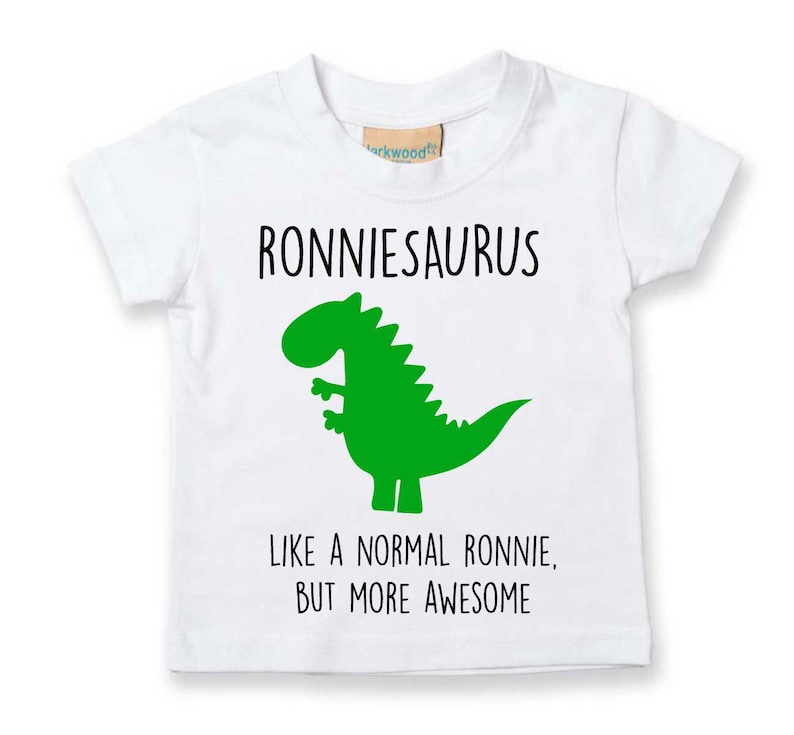 May include: White t-shirt with a green dinosaur graphic and the text "Ronniesaurus Like a normal Ronnie, but more awesome".