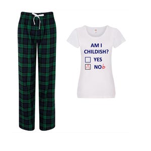 May include: A pair of green and navy plaid pajama pants with a white drawstring, next to a white t-shirt. The t-shirt has the text "AM I CHILDISH?" with check boxes for "YES" and "NOb".