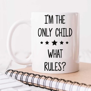 May include: White ceramic mug with black text that reads "I'm the only child what rules?" with five black stars above the word "what".