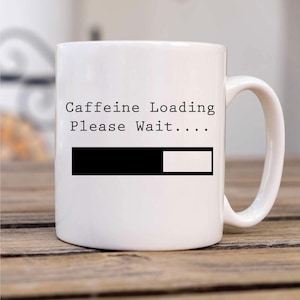 May include: White ceramic mug with the text "Caffeine Loading Please Wait..." and a black progress bar.