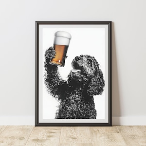 May include: Framed monochrome print featuring a dog raising a pint of beer. The dog, with dark, curly fur, looks upwards towards the beer, its tongue visible. The beer has a frothy head. The print is in a black frame.