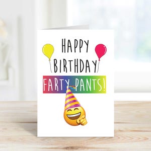 May include: A white card with a rainbow colored banner that says "Happy Birthday Fart Pants!" with a yellow and pink balloon on either side of the text. A smiling emoji wearing a party hat is below the banner.
