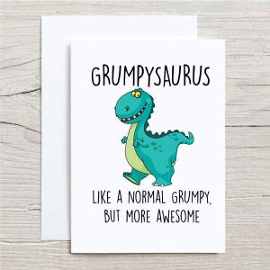 May include: A white card with a green dinosaur cartoon and the text "Grumpysaurus Like a normal grumpy, but more awesome".