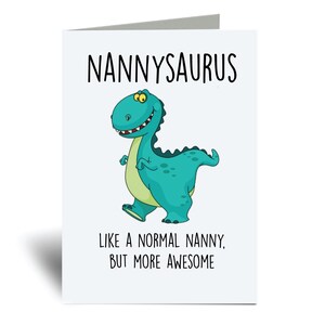 May include: A greeting card with a cartoon dinosaur illustration. The dinosaur is green with yellow eyes and a toothy grin. The text on the card reads "Nannysaurus, Like a normal nanny, but more awesome."