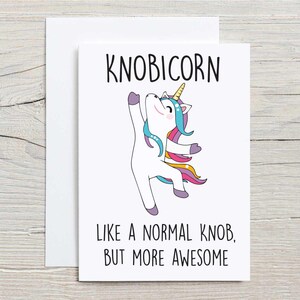 May include: A white card with a cartoon unicorn with a rainbow mane and tail. The text on the card reads "KNOBICORN like a normal knob, but more awesome".