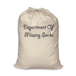 May include: A white canvas laundry bag with a drawstring closure. The bag has the text "Department of Missing Socks" printed on the front.