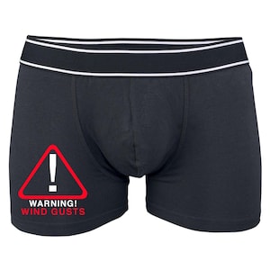 May include: Black boxer briefs with a white waistband and a red warning sign that says "WARNING! WIND GUSTS" in white text.