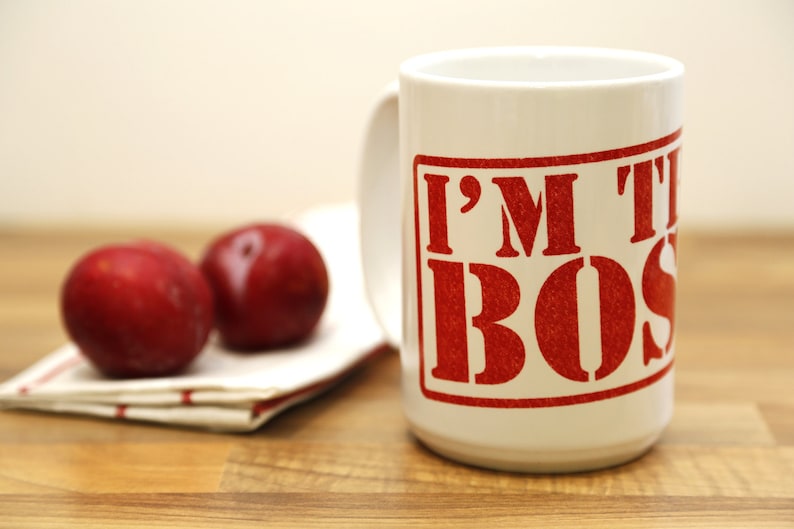 May include: White ceramic mug with a red graphic that says "I'M THE BOSS" in a bold, blocky font.