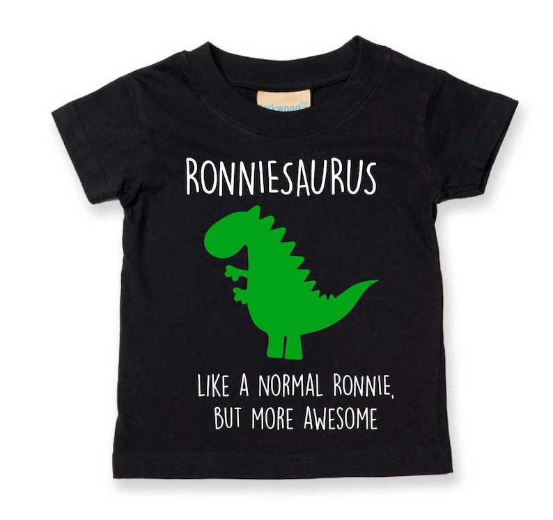 May include: Black t-shirt with a green dinosaur graphic and the text "RONNIESAURUS LIKE A NORMAL RONNIE, BUT MORE AWESOME".