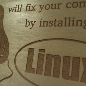 May include: A wooden sign with a cartoon penguin and the text "will fix your comp by installing Linux".