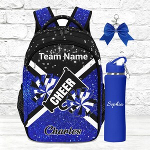 May include: A black and blue glitter-patterned backpack featuring the text Team Name, Cheer, and Charles, accompanied by a matching blue water bottle with the name Sophia and a blue glitter hair bow with a silver center accent piece.