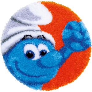 May include: A blue and white plush rug featuring a smiling cartoon character wearing a white hat. The character has a blue body, white eyes, and a red mouth. The rug is round and has a fluffy texture.