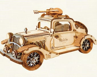 May include: A wooden model kit of a vintage car with a guitar on the roof. The car is painted in a light wood color and has the word "Rolife" printed on the side.