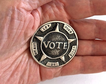 8 large, sterling silver "VOTE, Let Your Voice Be Heard" buttons with matching brooch; 1 5/8 inches diameter, 235.3 grams