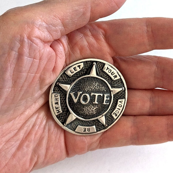 8 large, sterling silver "VOTE, Let Your Voice Be Heard" buttons with matching brooch; 1 5/8 inches diameter, 235.3 grams