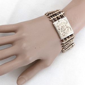 Hand wrought gilt silver link bracelet, engraved floral and foliate clasp motif, 7 5/8 inches long, 60.2 grams.
