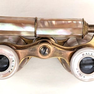 May include: Antique brass opera glasses with a mother-of-pearl barrel. The lenses are marked "Balland F2 Paris".