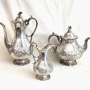 Victorian Sheffield, sterling silver coffee and tea pots with creamer; fine chasing and repousse, bird finials; 66.84 troy ounces