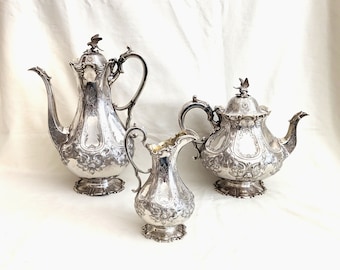 Victorian Sheffield, sterling silver coffee and tea pots with creamer; fine chasing and repousse, bird finials; 66.84 troy ounces