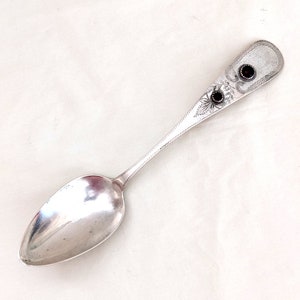 1842 coin silver serving spoon with two red glass &quot;gems,&quot; 9 inches long; 40 grams