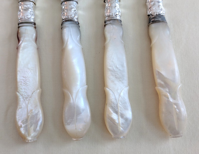 Set of 4 Victorian carved pearl handle silver plated knives with sterling collar