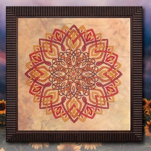 Könnte beinhalten: Ein gerahmtes Kreuzstich-Design mit einem farbenfrohen Mandala mit komplizierten Mustern in Rot-, Orange-, Gelb- und Lilatönen.