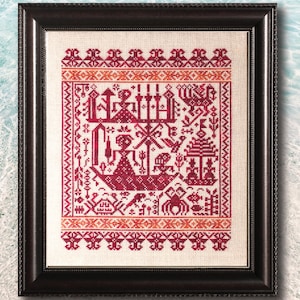 May include: A framed cross-stitch embroidery featuring a red and orange colour scheme. The design depicts a stylised figure with a crown and various geometric patterns.