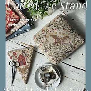 May include: Three cross-stitch patterns for needlepoint, featuring a house, birds, and a patriotic design. The patterns are titled "United We Stand" and are from Blackbird Designs.