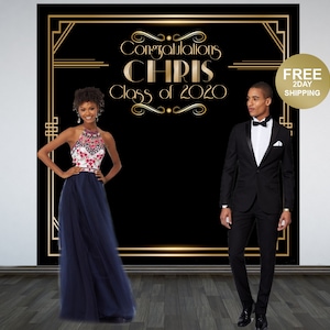 May include: A black and gold graduation backdrop with the text "Congratulations Chris Class of 2020".