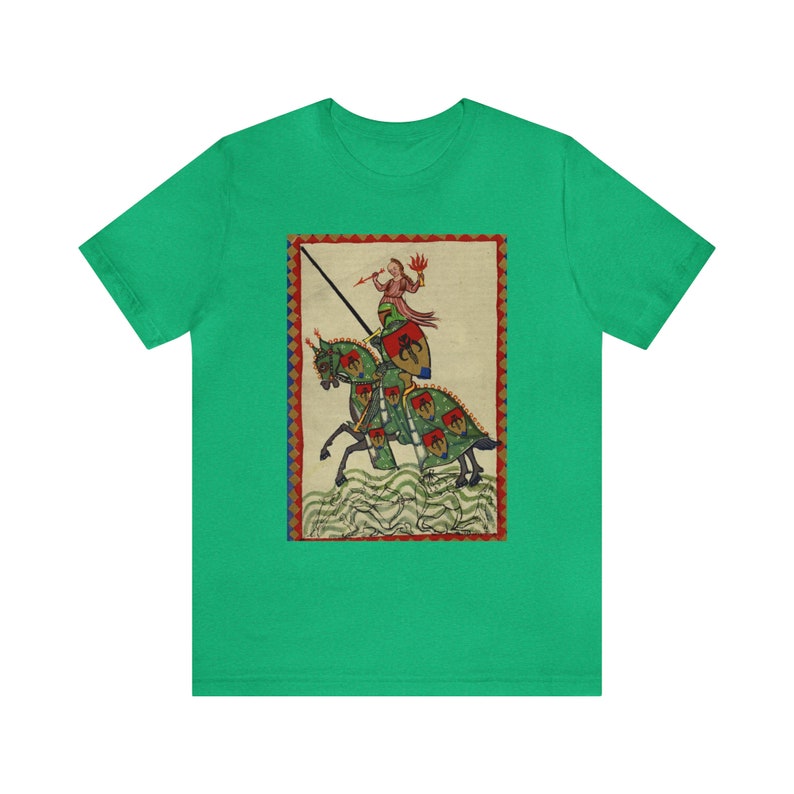 May include: Green t-shirt featuring a medieval illustration of a knight on horseback. The artwork depicts a knight in armor with a spear, riding a horse with green and red accents. The background is a cream color with a red border.