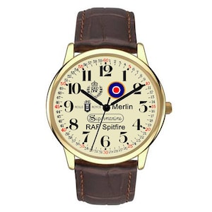May include: A gold-toned wristwatch with a cream-colored face and a brown leather band. The watch face features black numerals, a red and blue emblem, and the text "RAF Spitfire" and "Merlin".