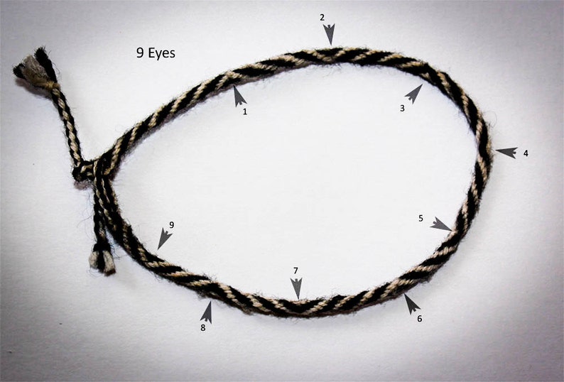 May include: A black and white braided rope with nine loops, labeled "9 Eyes" and numbered 1 through 9.