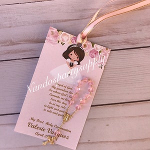 May include: Pink and gold First Holy Communion favor with a pink rosary and a card with the text "Angel of God, My guardian dear, To whom God's love commits me here, Ever this day be at my side to light and guard to rule and guide. My First Holy Communion Valerie Vasquez April 28"