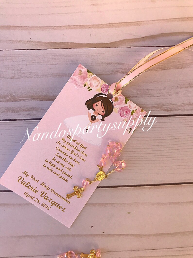 May include: Pink and gold First Holy Communion favor with a pink rosary, a floral design, and the text "My First Holy Communion Valerie Vazquez April 28, 2018".