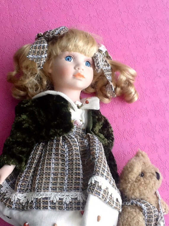 porcelain doll with teddy bear