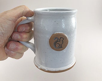 A White Mug with a Cat Medallion